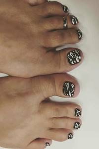 White pattern on black pedicure