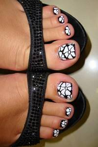 Black and white pedicure with flower pattern