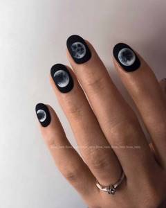 Black matte manicure with moon phase designs