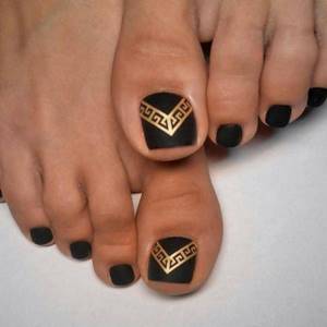 Black pedicure with gold decoration
