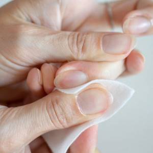 European manicure step 5 - removing residual gel with a napkin