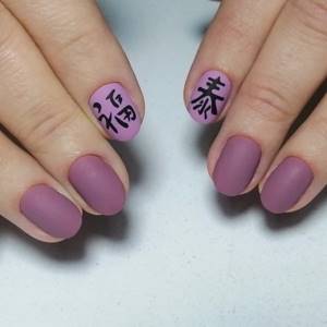 purple manicure with hieroglyphs
