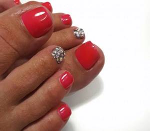 Coral pedicure with silver glitter and rhinestones