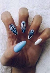 Beautiful almond-shaped nails coated with gel polish in blue tones with a pattern of diamonds, triangles, clear lines.