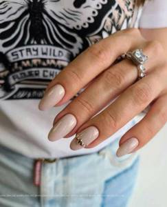 Beautiful beige manicure with sparkles