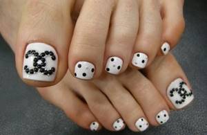 Beautiful pedicure in white colors with rhinestones