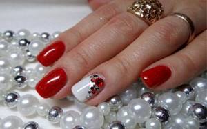 Red liquid stones on nails, photo