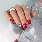 Red manicure and design on one nail