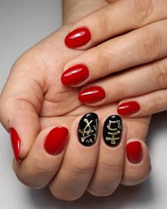red manicure with hieroglyphs