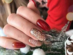 Red manicure with gold glitter