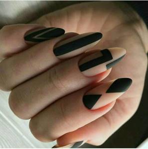 Matte nails and black geometry on almond nails.