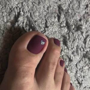 Matte burgundy shellac pedicure with shiny heart