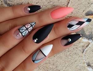 Matte manicure on pointed almond-shaped nails with rhinestones and clear geometry.