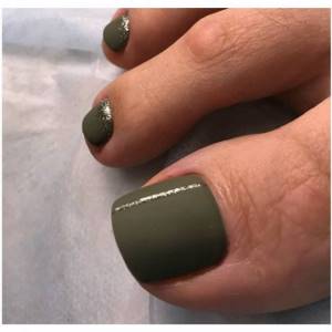 Matte green shellac pedicure with glitter moon design