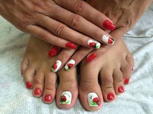 Fashionable manicure pedicure - idyll design on the nails of the hands and feet