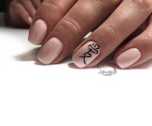nude manicure with hieroglyphs