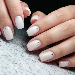 One-color milky manicure square with rhinestones