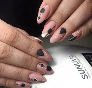 Original manicure in nude tones with patterns on all nails, black squares, triangles.