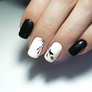 Stylish black and white manicure with spring composition