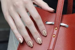 Handbag as a background for a nail design photo