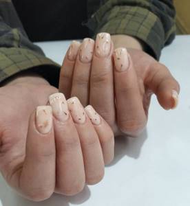 Light beige manicure with gold design on square extended nails