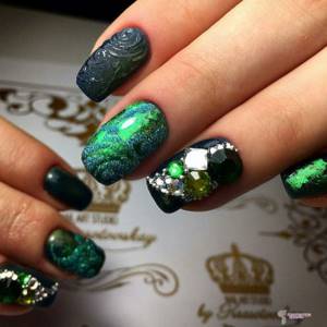 Green manicure with stones